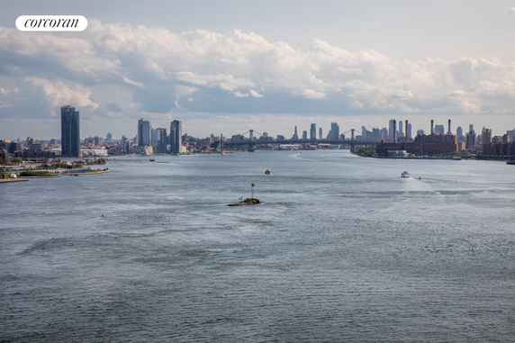 Panoramic view of a river with a city skyline in the background.