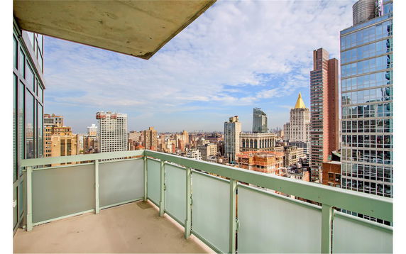 Panoramic view of city skyline from a balcony.