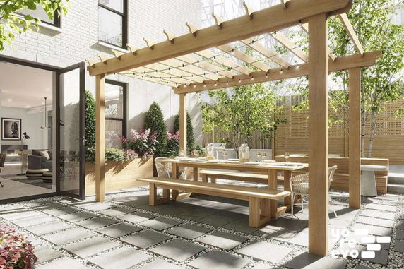 Outdoor patio area with wooden pergola, dining table, and benches.