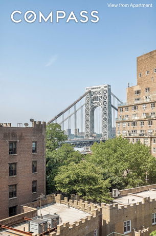 View of a large bridge with nearby residential buildings and trees.