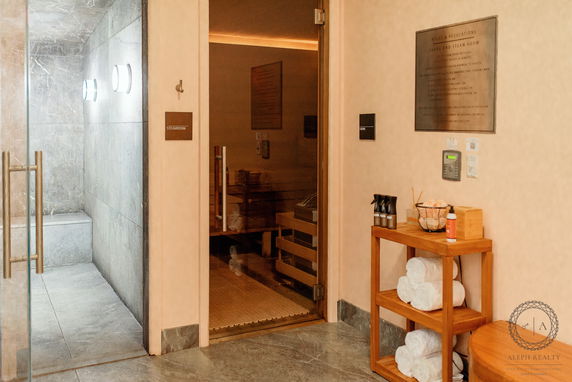 Indoor sauna and steam room area with towels and amenities.