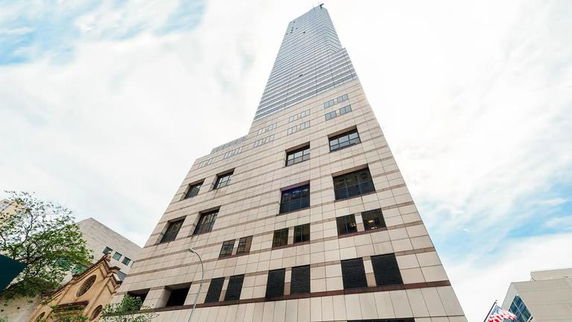 Front view of a high-rise building with multiple stories and a modern design.