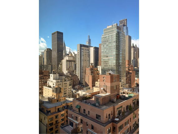 Panoramic view of a city skyline with various tall buildings.
