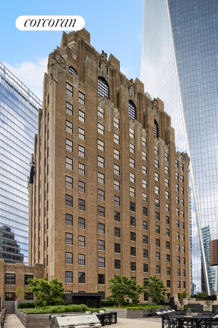 Front view of a tall, ornate brick building with decorative elements and multiple windows.