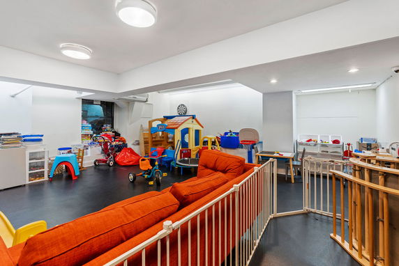 Room with various children's toys and play equipment.