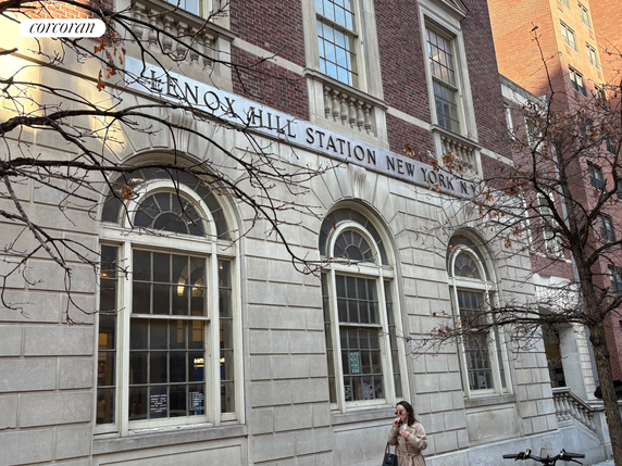 Front view of a historical brick building with arched windows.