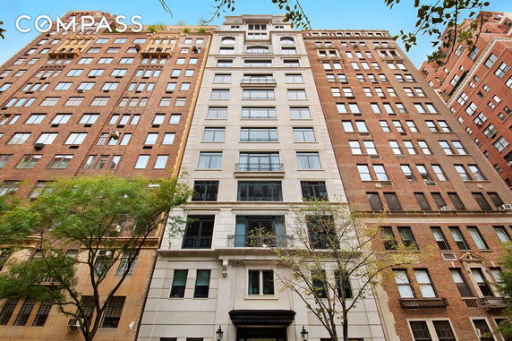 Front view of a multi-story building with a mixed facade.