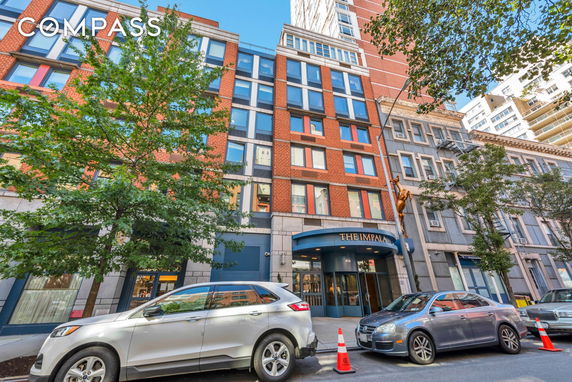 Front view of a multi-story building with modern facade and entrance.