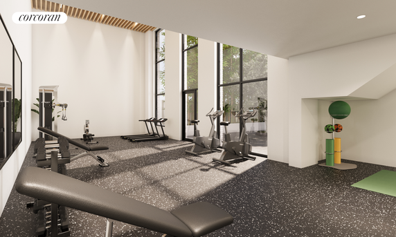 Indoor gym area with exercise equipment and large windows.