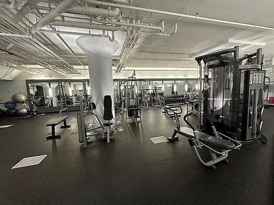 Interior view of a gym with various exercise equipment.