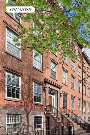 Front view of a multi-story brick building with classic architectural features.