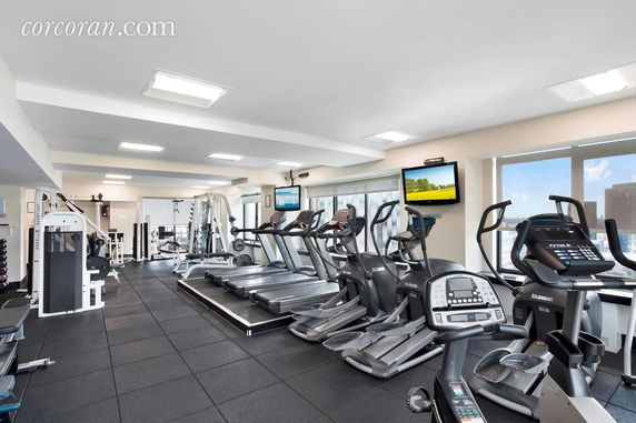 Interior view of a modern gym with exercise machines and equipment.