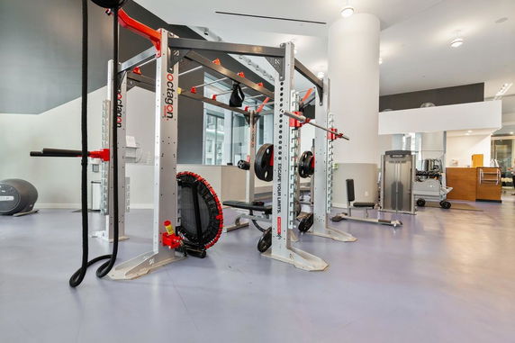 Indoor gym area with fitness equipment and weight lifting setup.