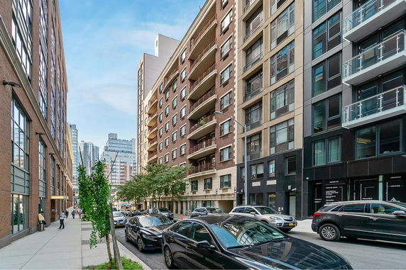 Street view featuring multiple multi-story residential buildings with balconies.