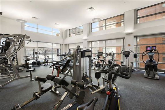 Interior view of a gym area with various exercise machines and equipment.