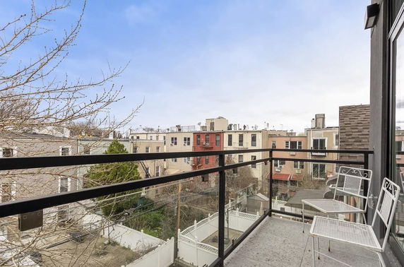 View from a balcony showing surrounding residential buildings.