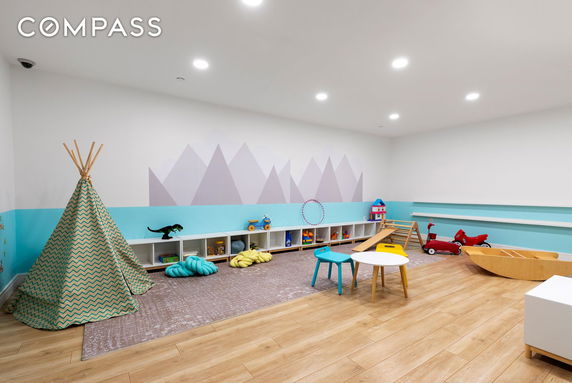 Indoor play area with toys and a small teepee tent.