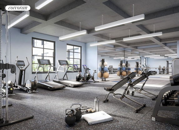 Gym area with exercise equipment including treadmills, stationary bikes, and weights.