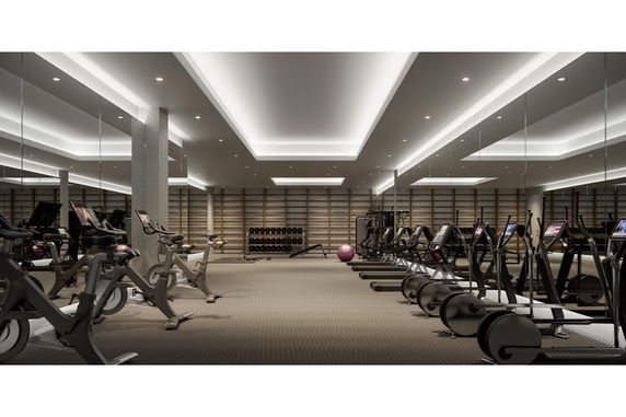 Interior view of a gym with exercise equipment and mirrors.