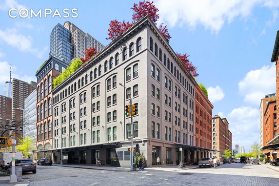 Front view of a multi-story building on a city street corner.
