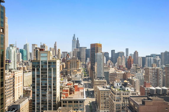 Panoramic view of a city skyline with numerous high-rise buildings.