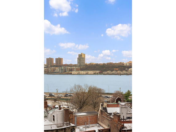 Wide angle view of a river and city skyline in the background.