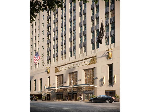 Front view of a multi-story hotel building with decorative elements above entrance.