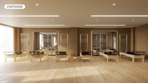 Interior view of a room equipped with pilates reformer machines.