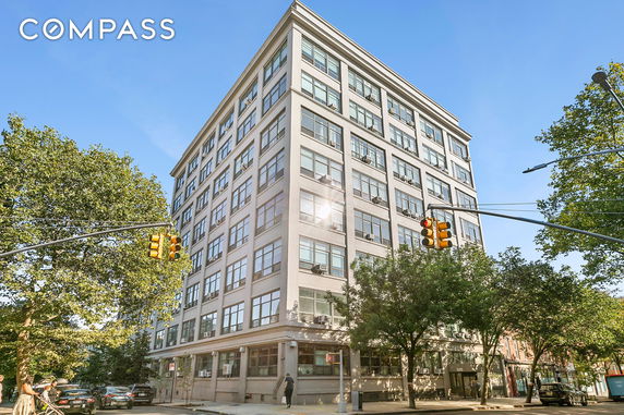 Front view of a multi-story building on a street corner.