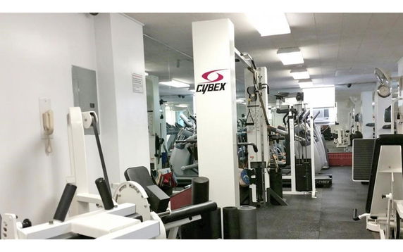 Indoor gym area with various exercise equipment.