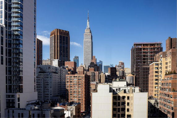 View of urban skyline with tall buildings and blue sky.