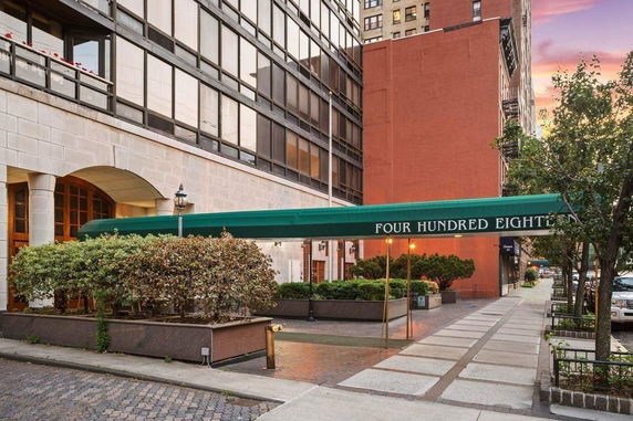 Front view of a multi-story building with a covered entrance walkway.