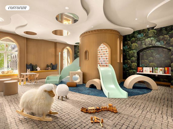 Indoor play area with slides, rocking toys, and a tree-themed wallpaper.