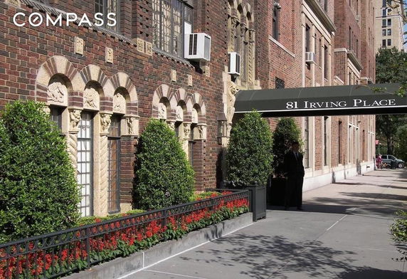 Front view of a brick building with decorative windows and awning.