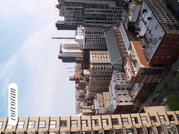 View of multiple tall buildings and rooftops from a high vantage point.