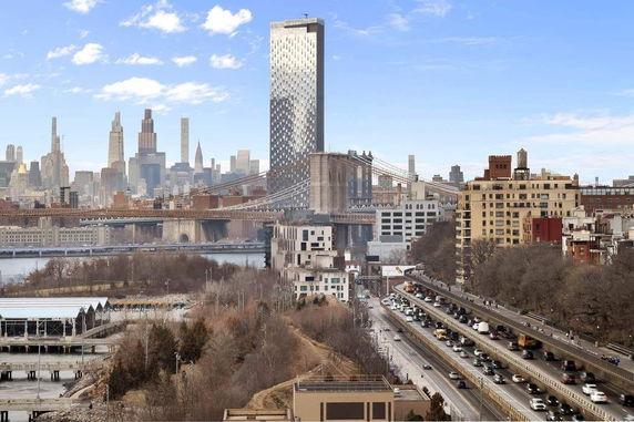 Cityscape view with a prominent bridge and tall buildings in the background.