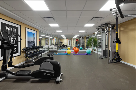 Interior of a modern gym with exercise equipment and fitness area.