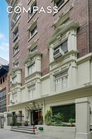 Front view of a multi-story building with ornamental architecture.