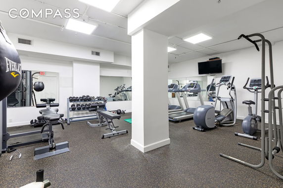Indoor gym area with various exercise equipment.