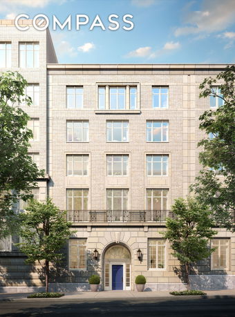 Front view of a multi-story building with large windows and a blue door entrance.