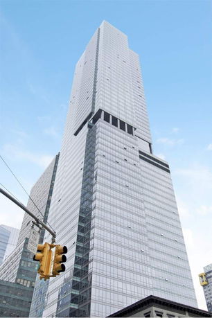 Front view of a tall skyscraper building with a modern glass facade.