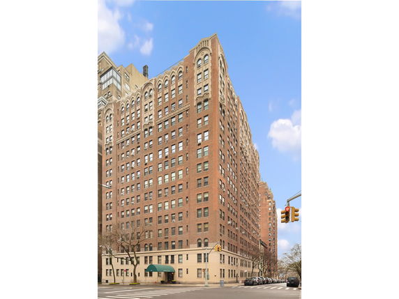 Front view of a multi-story brick building with arched windows.