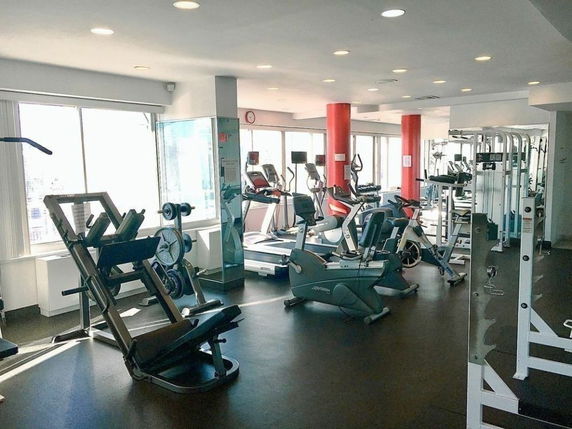Interior view of a gym area with various exercise equipment.