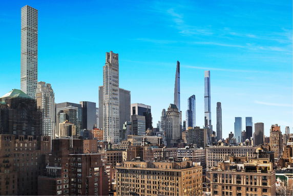 Panoramic view of a city skyline with numerous skyscrapers.