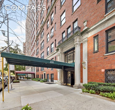 Front view of a multi-story brick building with an entrance canopy.