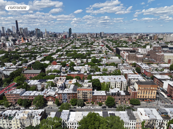 Panoramic view of a densely built urban area with rows of buildings and a distant city skyline.