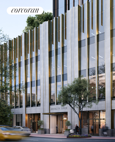 Front view of a modern multi-story building with large glass windows and vertical architectural elements.