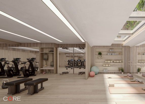 Interior view of a gym and yoga studio with exercise equipment and mats.