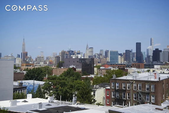 Panoramic view of a city skyline with various tall buildings and clear blue sky.