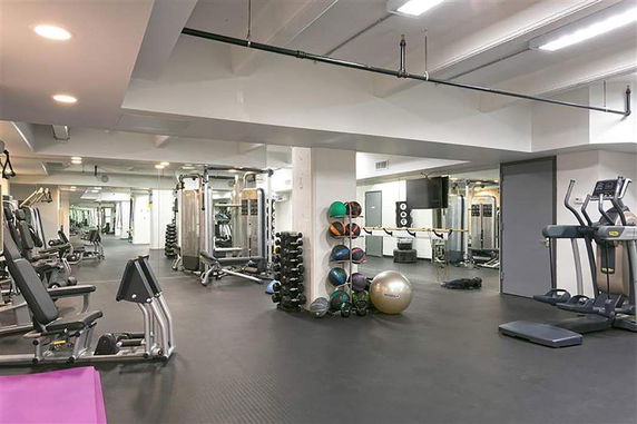 Interior view of a gym with various exercise equipment and machines.